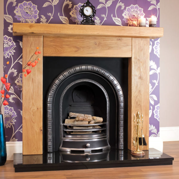 Ashford rustic oak beam fireplace shown in a light oak finish with a Henley cast iron arch insert and a solid fuel basket